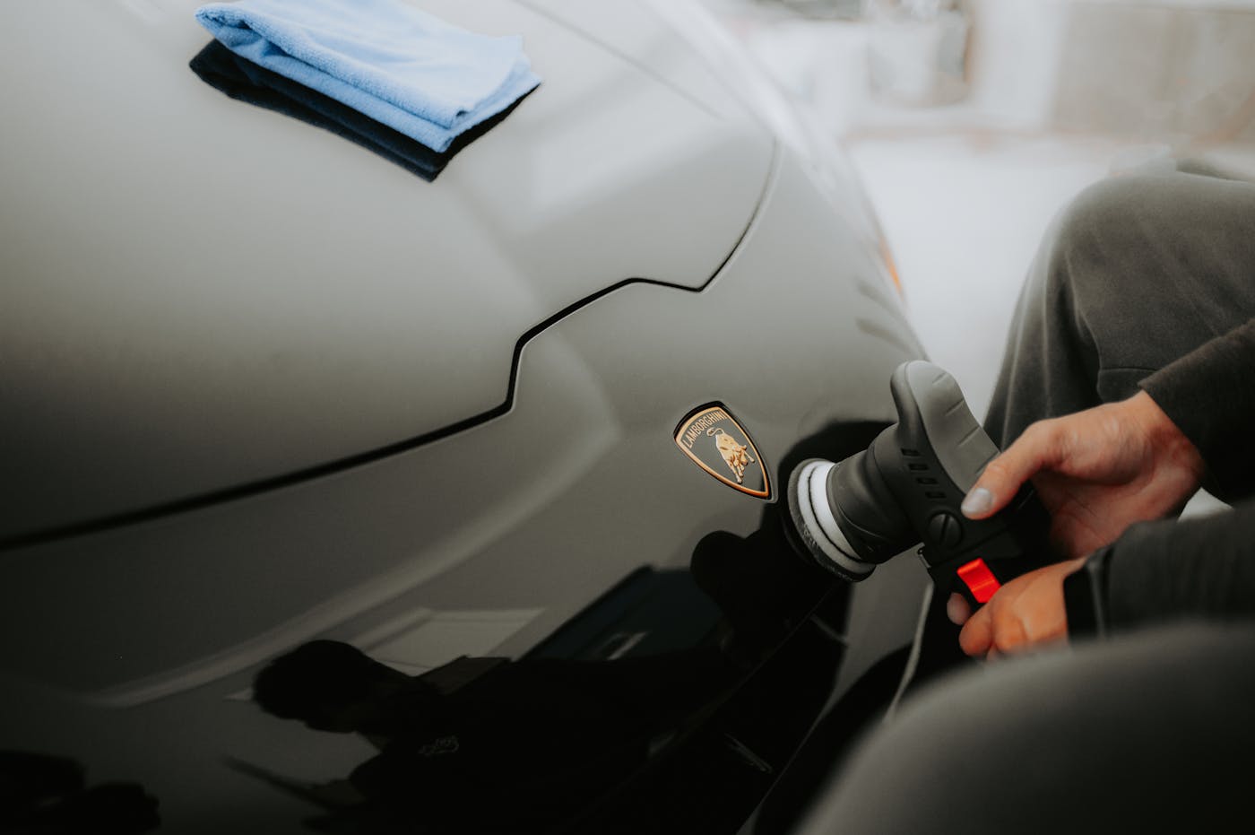 Technician applying PeelClear protective coating in a climate-controlled booth